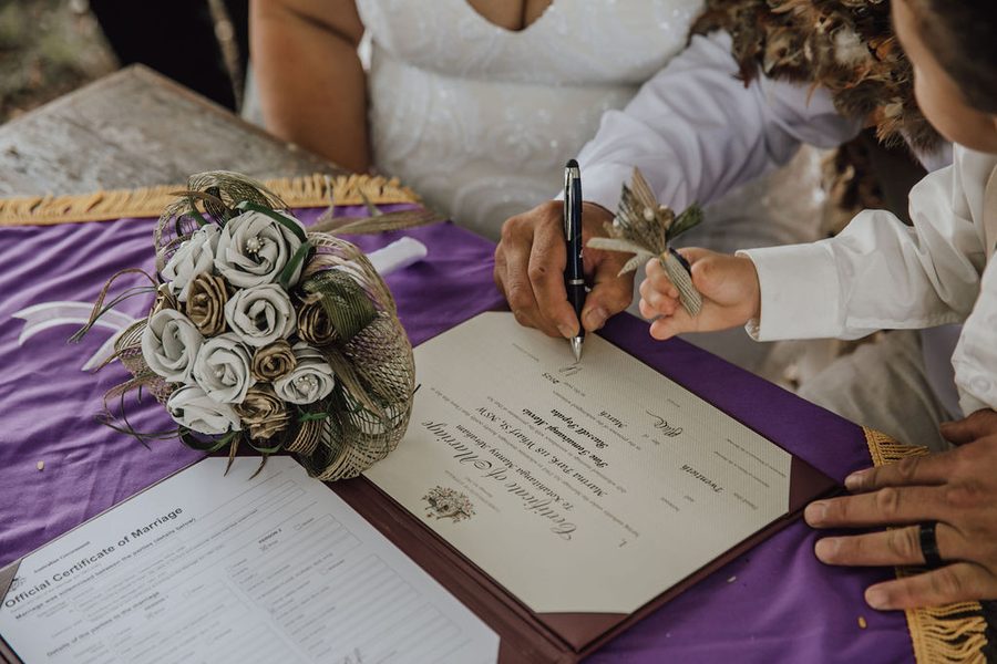 A couple sign their marriage certificate during their NZ Wedding