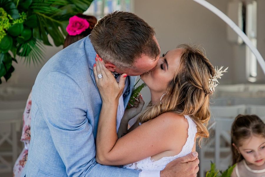 A newly wed couple kissing