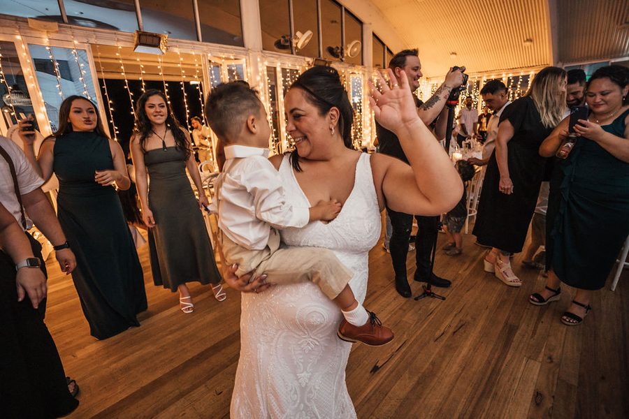 A beautiful Maori bride holds her son as they dance at their NZ Wedding