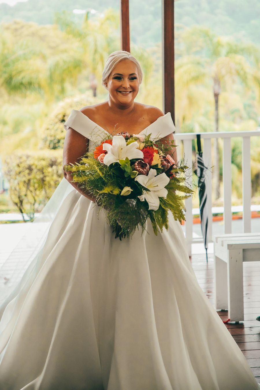 A Bride walking down the aisle with a bouquet of lillies